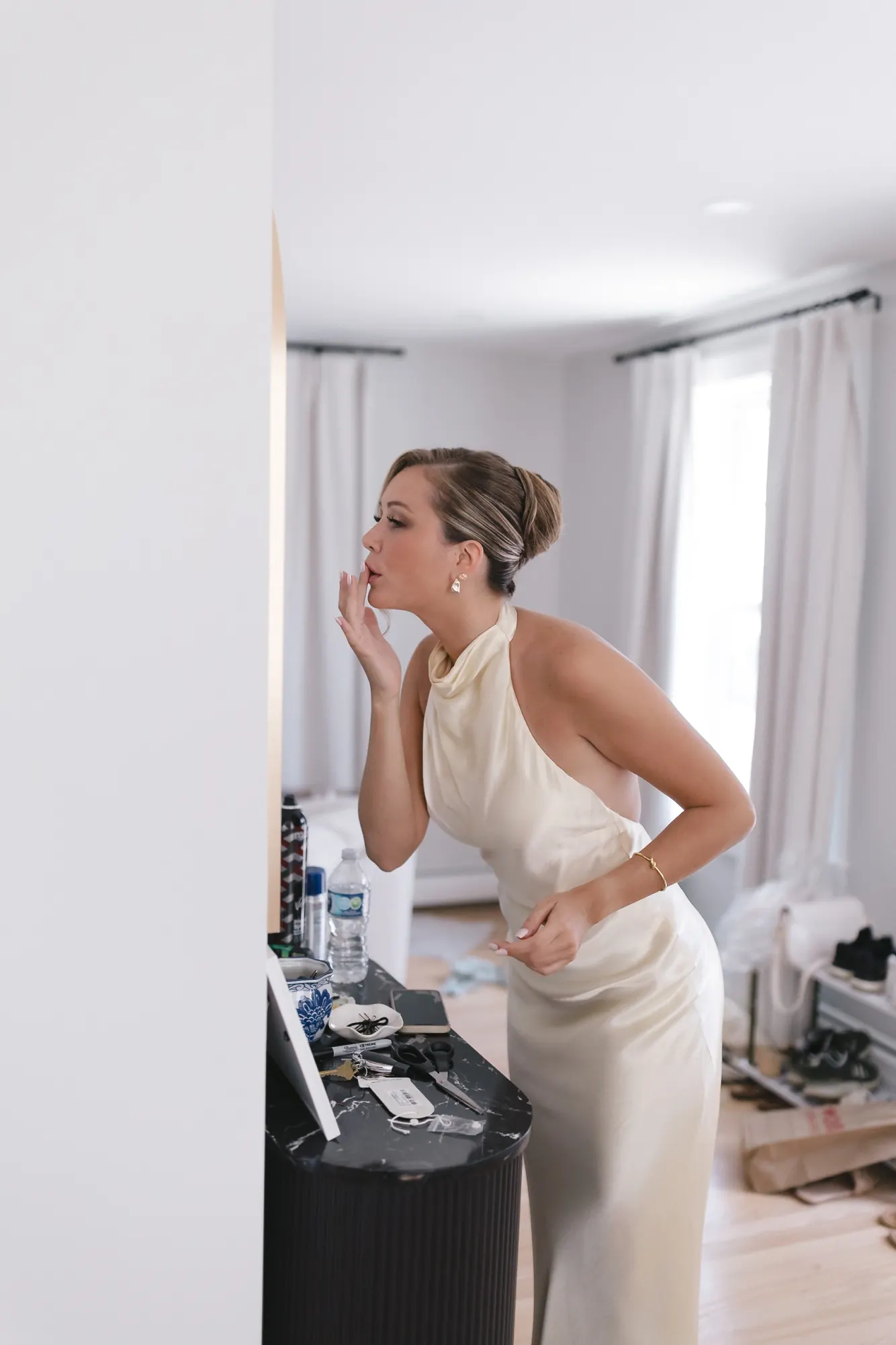 Bride at the vanity finishing getting ready for her Newport wedding