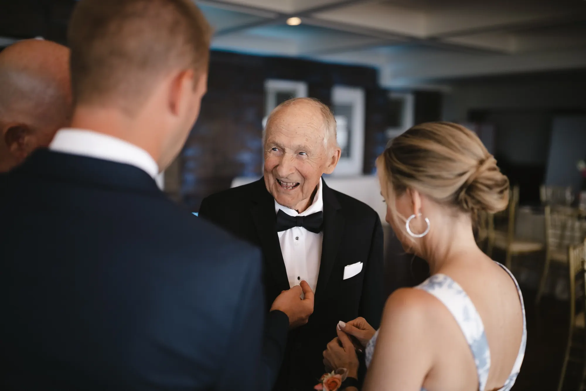 The couple share a candid moment with family before the ceremony at OceanCliff