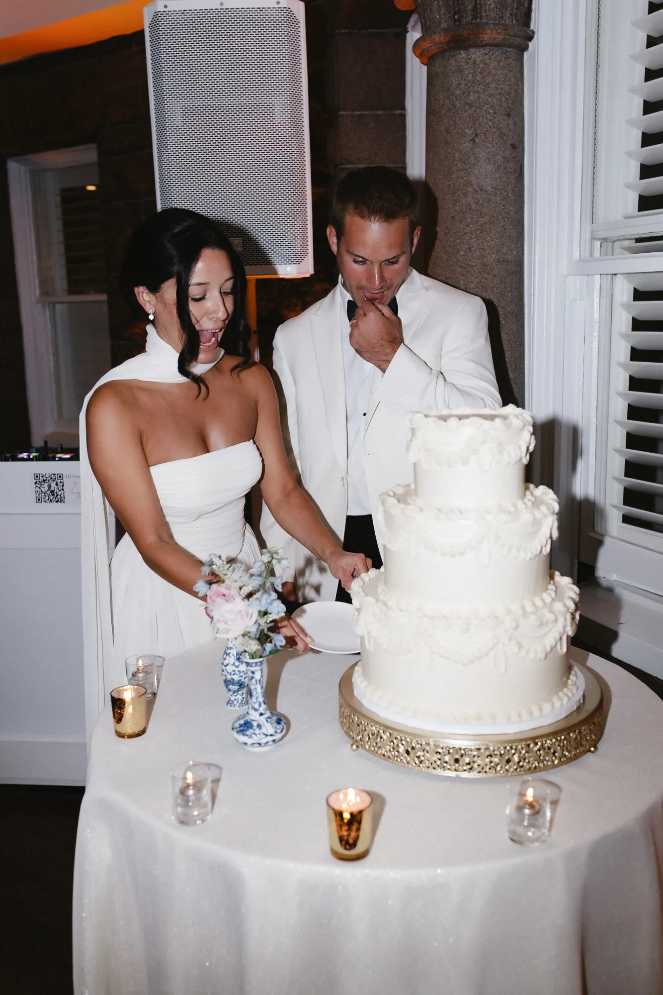 Bride and groom cut their wedding cake at OceanCliff, Newport