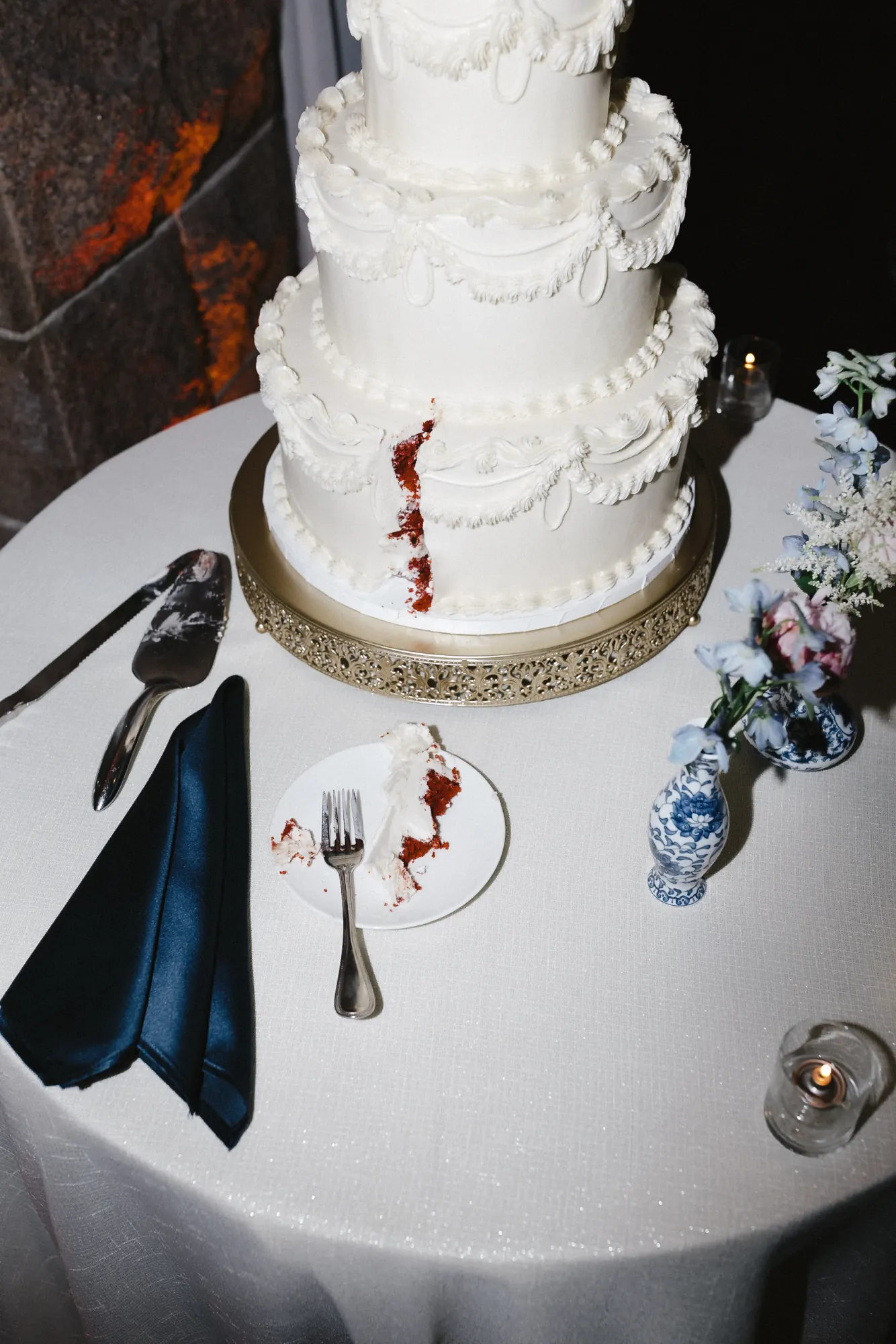 The cut wedding cake revealing red velvet inside with a navy napkin at OceanCliff