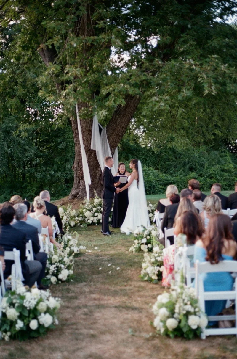 Meghan and Pat outdoor ceremony under tree at Floriana Ipswich