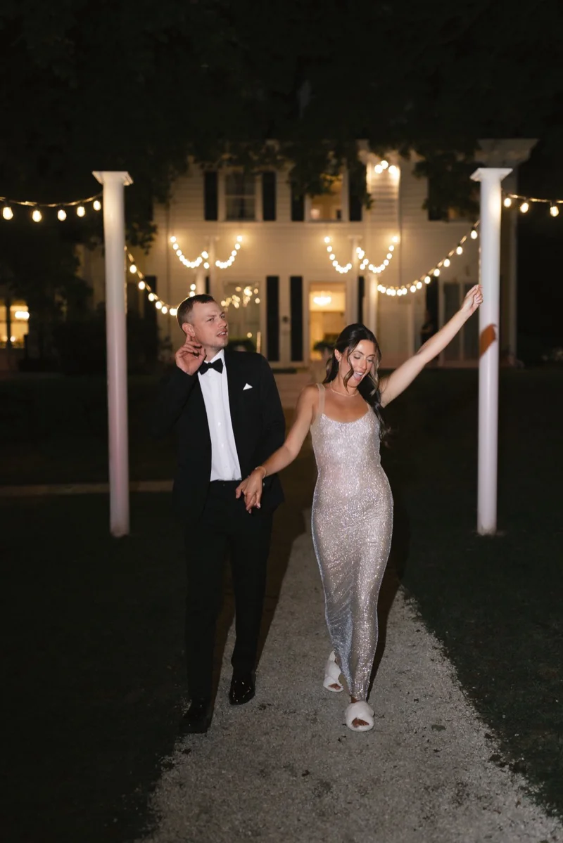 Meghan and Pat grand exit under string lights at Floriana